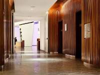 A tunnel of curved walnut, 46' long. Every guest of the Conrad Hotel passes through this elevator lobby fabricated by Pure Timber LLC