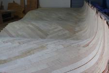 The cold-molded deck is 1/2 inch thick before the final layer of 1/8 inch thick walnut goes on